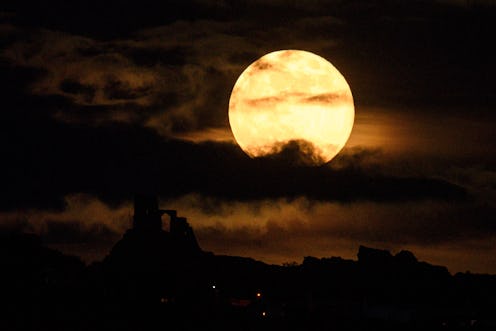 A supermoon rises over Mow Cop Castle near Stoke-on-Trent, central England on May 7, 2020. (Photo by...