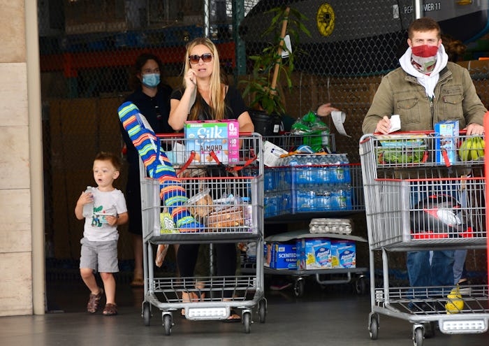 Huntington Beach, CA - May 17: Masked and unmasked shoppers leave Costco at Bella Terra in Huntingto...