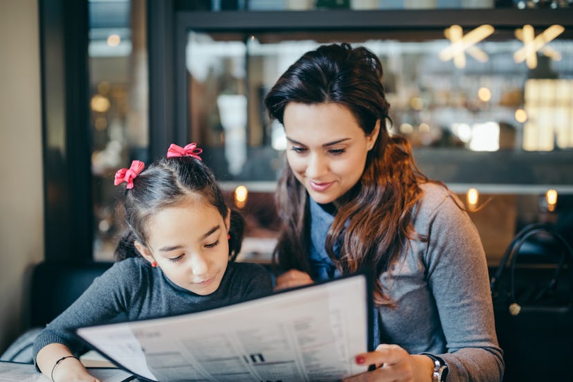 Reading the menu together is one restaurant tip from parents for picky eaters.