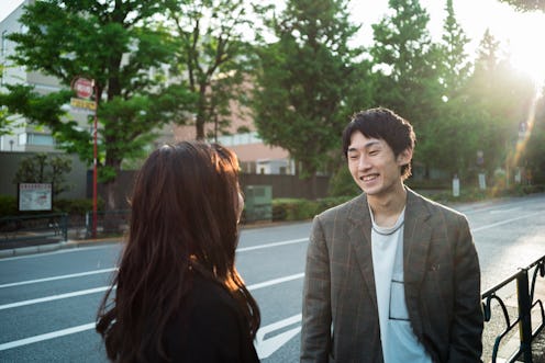Japanese young couple having a fun conversation on street outdoor. Taken in Tokyo, Japan.