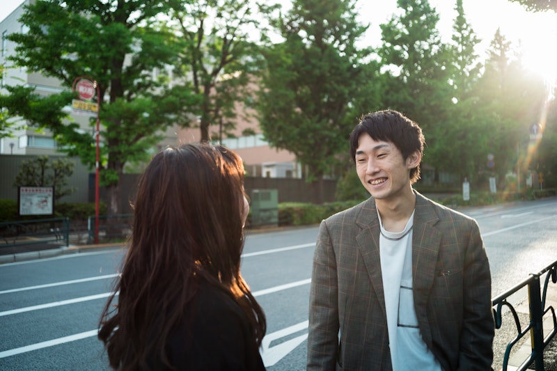 Japanese young couple having a fun conversation on street outdoor. Taken in Tokyo, Japan.
