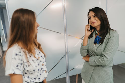 Female colleagues chatting on break in office