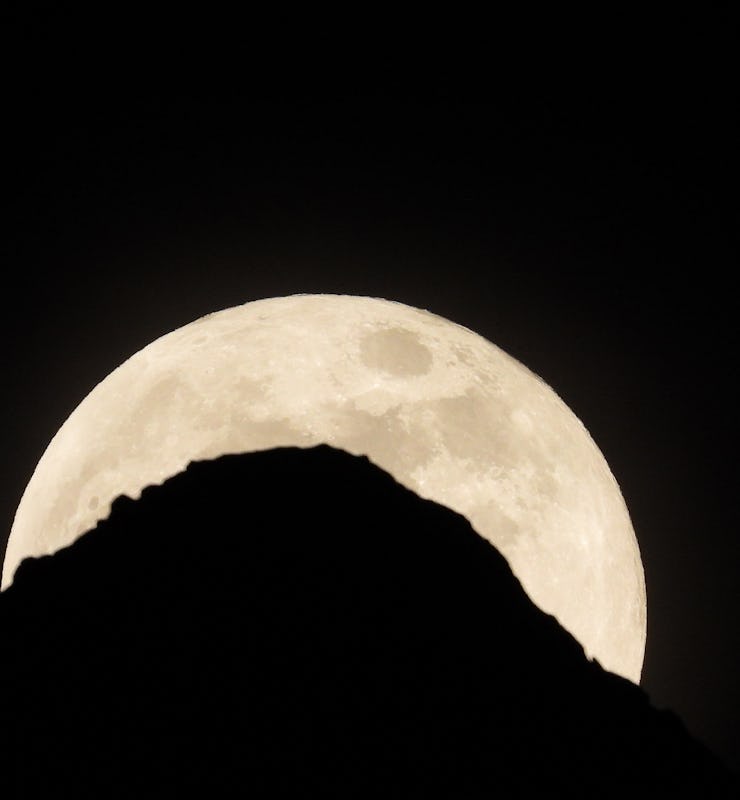 The moon is pictured above Leh on May 26, 2021 during a total lunar eclipse as stargazers across the...