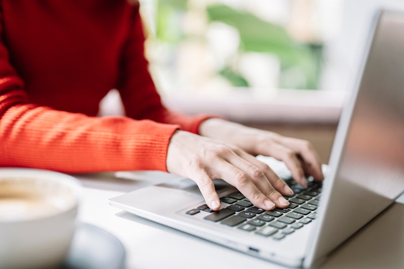 woman typing on her laptop