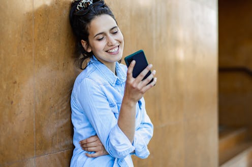 Portrait of young woman with smart phone