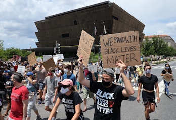 WASHINGTON, DC - JUNE 19: People march from The National Museum of African American History and Cult...