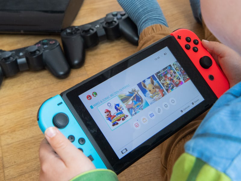 31 March 2020, Lower Saxony, Hanover: ILLUSTRATION - A child is playing with a Nintendo Switch game ...