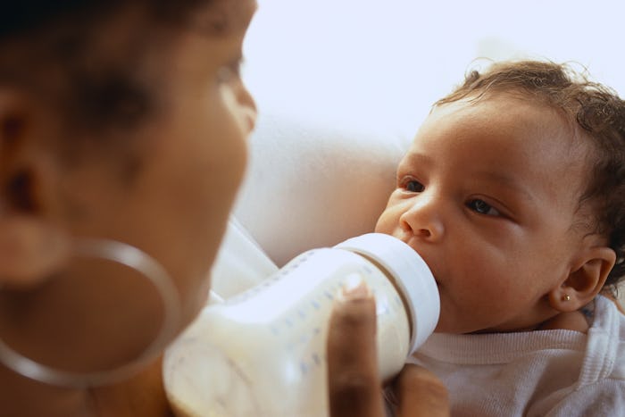 mom feeding baby bottle of milk