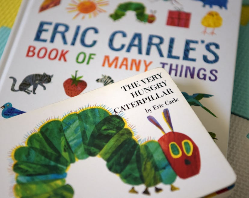 This photo illustration taken on May 26, 2021 shows Eric Carle's "The Very Hungry Caterpillar" and "...