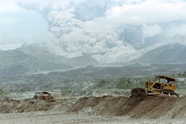 Bulldozers rush to repair collapsed Taug Dike, on June 29, 1991 as lake of trapped volcanic mudflow ...