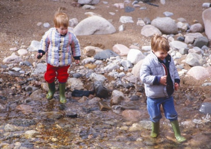 Princes William and Harry playing in the river.