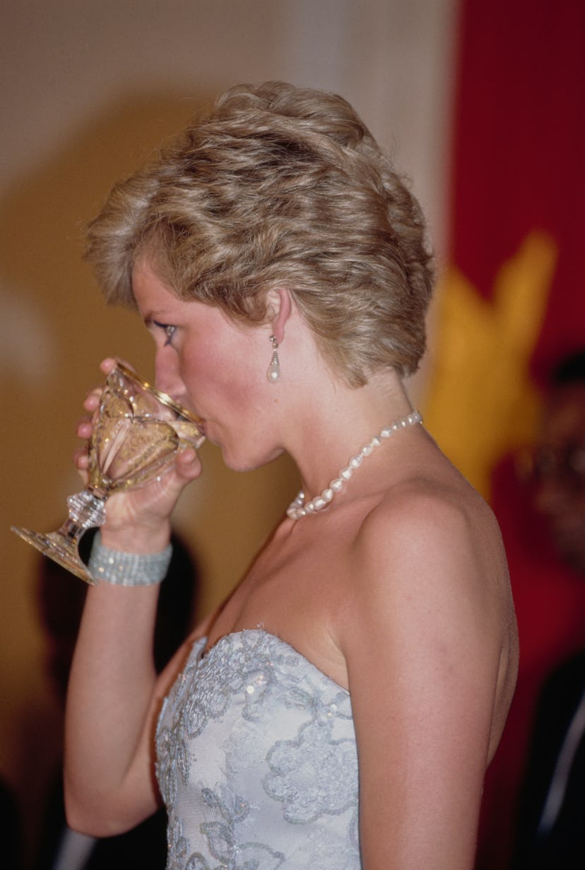 Princess Diana enjoys a cocktail.