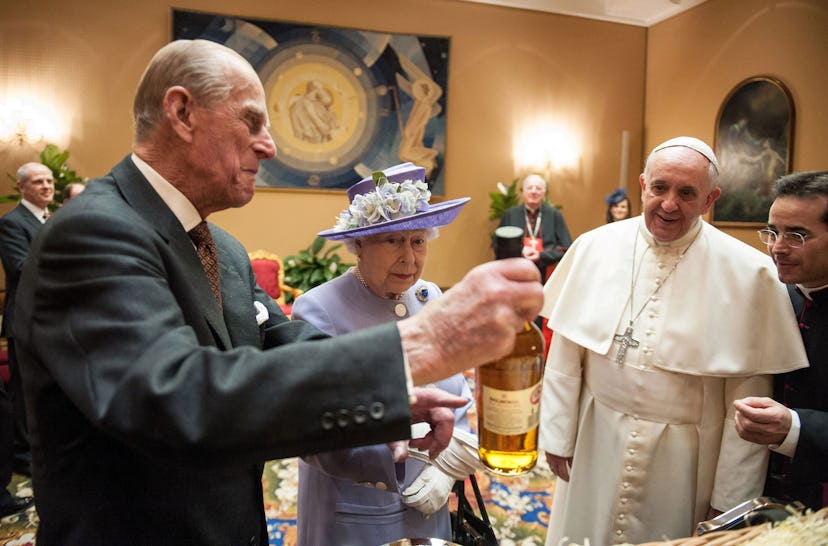 Queen Elizabeth and Prince Philip drink wine with the pope.