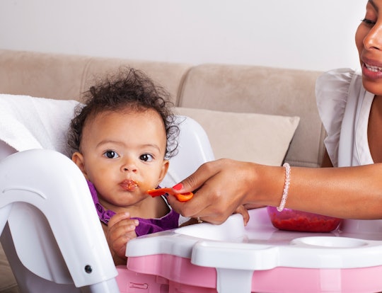 African-American Mother Spoon Feeding Her Baby