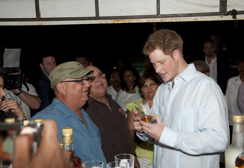 Prince Harry enjoys a local drink in Belize.