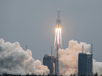 A Long March 5B rocket, carrying China's Tianhe space station core module, lifts off from the Wencha...