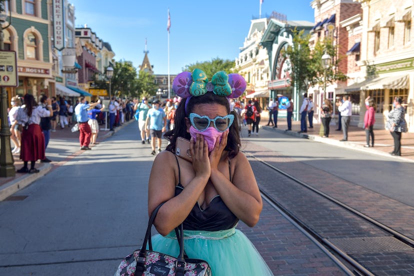 Anaheim, CA - April 30: A visitor to Disneyland get emotional as she walks up Main Street U.S.A. dur...