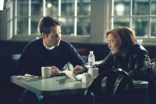 THE X-FILES - SEASON 7: Mulder (David Duchovny, L) and Scully (Gillian Anderson, R) search for clues...