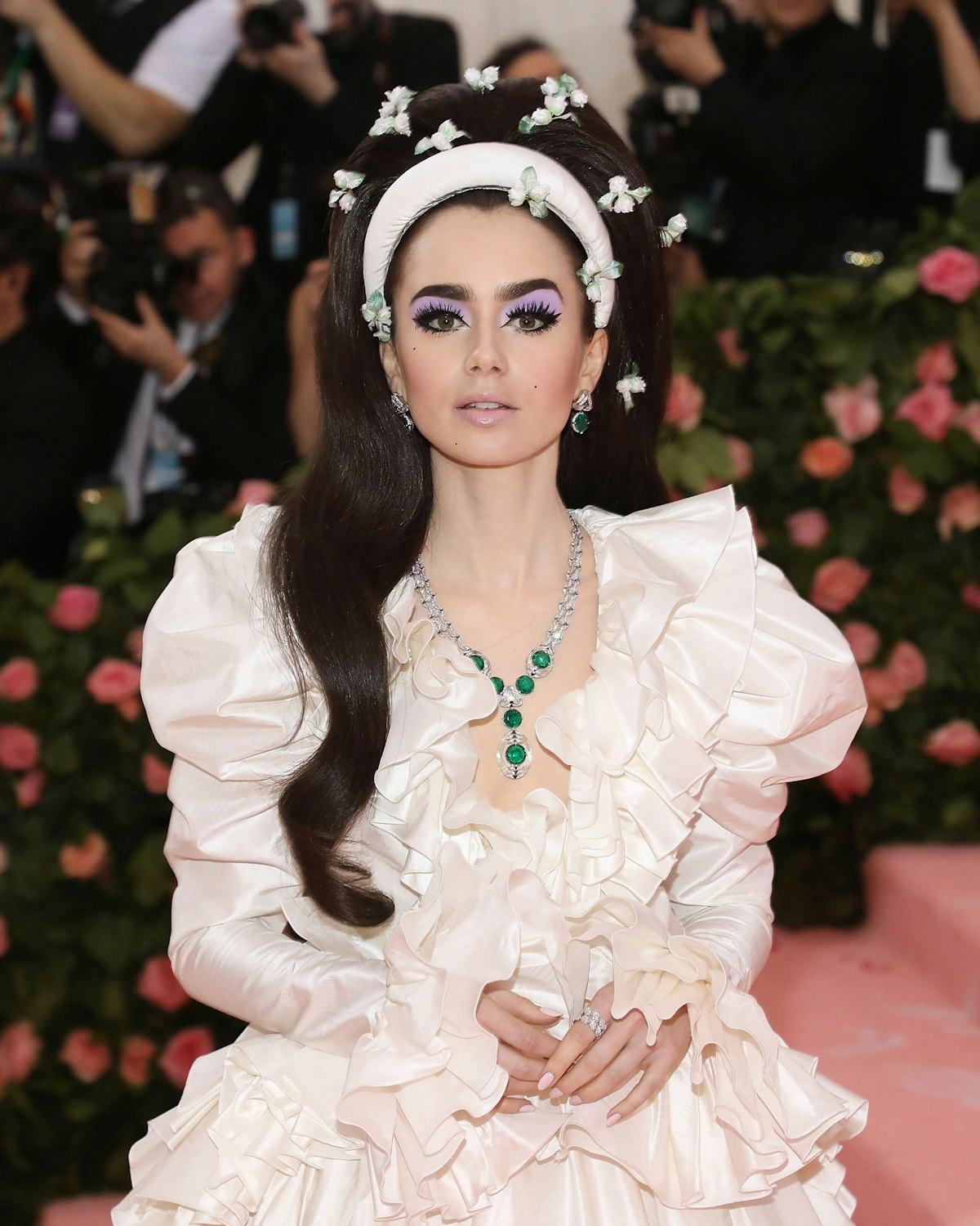 Lily Collins channeled Priscilla Presley's bouffant with added accessories.