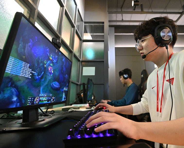 This picture taken on February 25, 2021 shows gamers during their training session at the T1 buildin...
