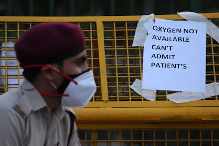 A notice pasted outside a makeshift isolation facility reads 'OXYGEN NOT AVAILABLE, CAN'T ADMIT PATI...