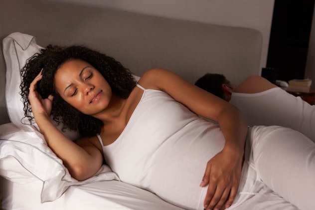 pregnant woman lying in bed