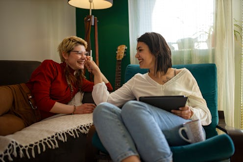 Young lesbian couple working together from home on drawing pad