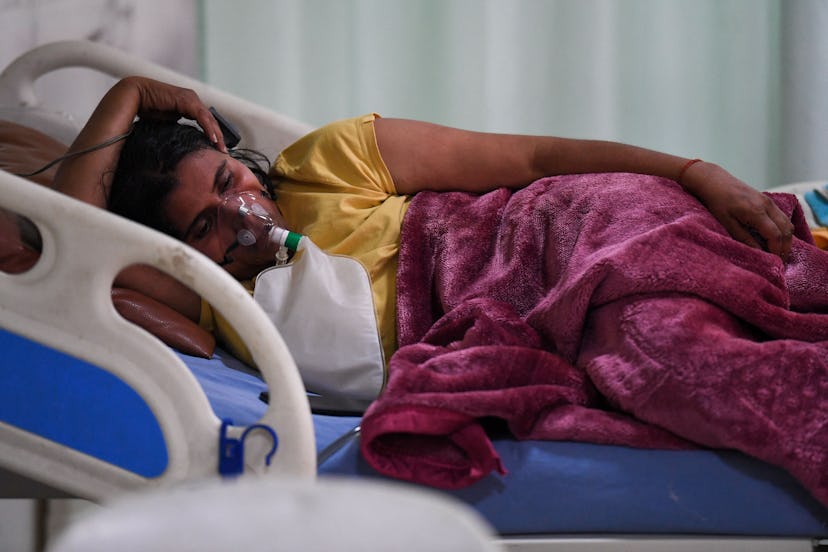 A Covid-19 coronavirus patient breaths with the help of an oxygen mask inside the Intensive Care Uni...