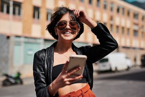 A woman on her phone using dating app Raya, an exclusive platform celebrities use to find love.