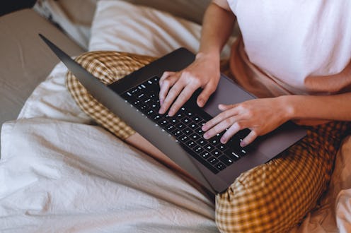 A woman signs up for OnlyFans anonymously from bed.