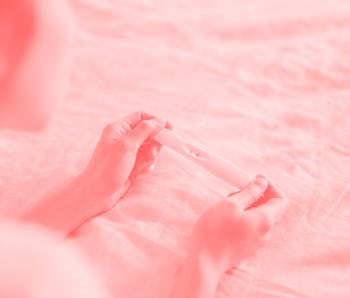 Close-up shot of unrecognisable Asian woman holding a pregnancy test kit and waiting for the result ...