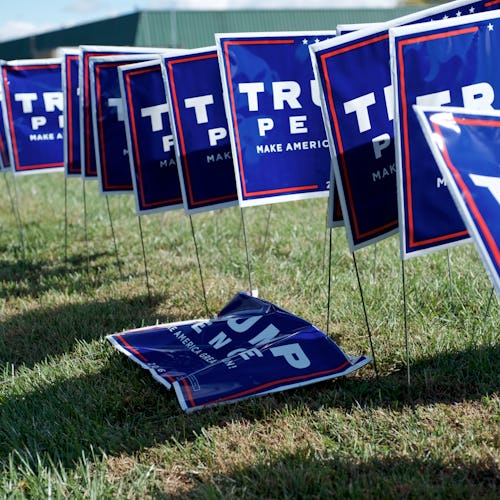 Trump/Pence Make America Great Again 2016 presidential campaign lawn signs sit on the side of the ro...
