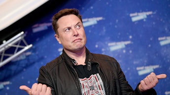 SpaceX owner and Tesla CEO Elon Musk (R) gestures as he arrives on the red carpet for the Axel Sprin...