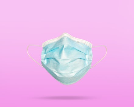 Covid-19 face mask on color background