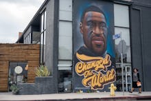 LOS ANGELES, CALIFORNIA - APRIL 21: A woman without a mask walks past a mural of George Floyd that r...