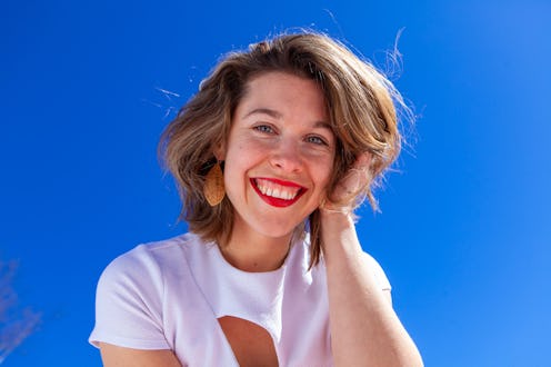 woman with short hair smiling at the camera