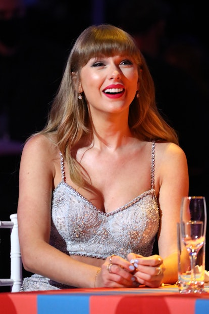 Taylor Swift wearing a sequined, beaded crop top and wearing her hair with blunt bangs at the BRIT A...