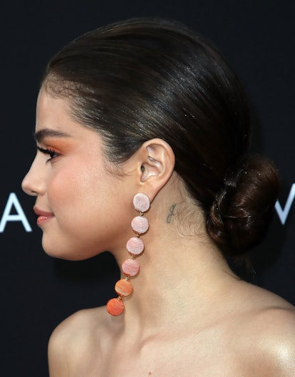 A closeup of the little tattoo Selena Gomez has behind her ears. 
