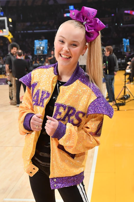 JoJo Siwa wears her signature hair bow as she attends a basketball game between the Los Angeles Lake...