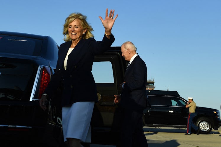 US First Lady Jill Biden (L) and US President Joe Biden gesture on arrival at Royal Air Force Milden...
