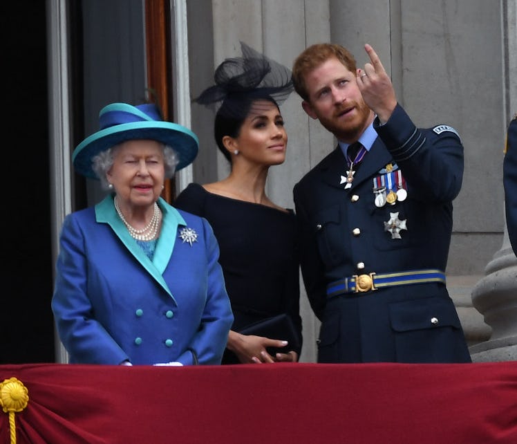 Queen Elizabeth ll, Meghan, Duchess of Sussex and Prince Harry, Duke of Sussex stand on the balcony ...