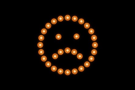 Displeased Face Composed of Illuminated Light Bulbs Against Solid Black Colored Background.
