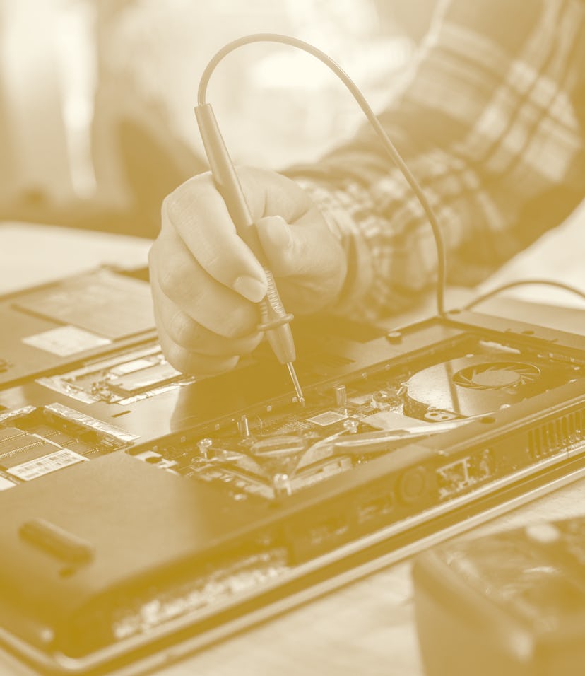 Hand holding recyclable plastic bottle in garbage bin.