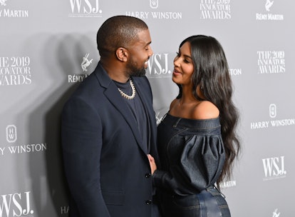 TOPSHOT - US media personality Kim Kardashian West (R) and husband US rapper Kanye West attend the W...