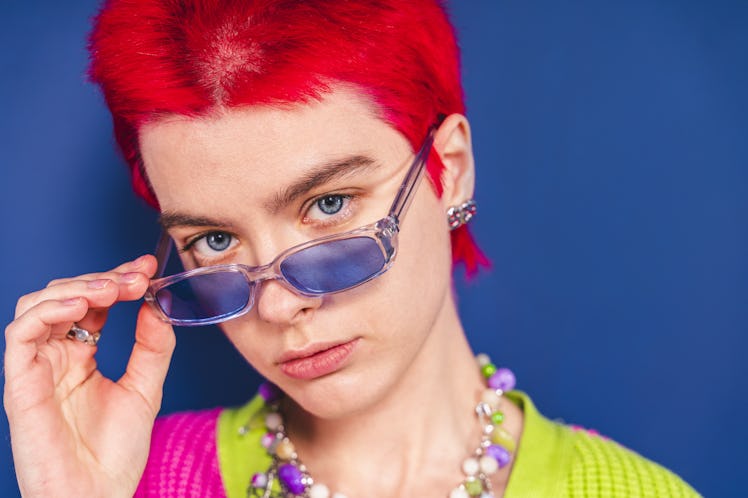 A young person with short, fire red hair, which can be damaged if colored incorrectly.