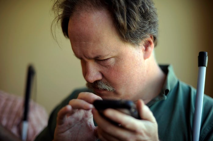 Chip Johnson is checking facebook with Voice Over system in iphone at the Colorado Center for the Bl...