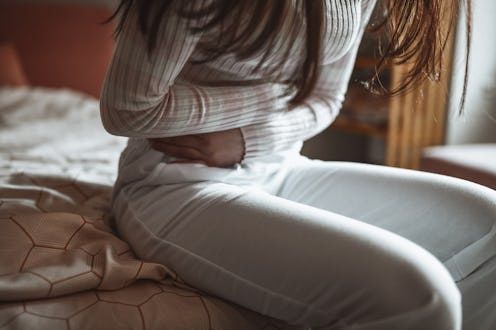 Female Struggling With Menstrual Cramps In Morning