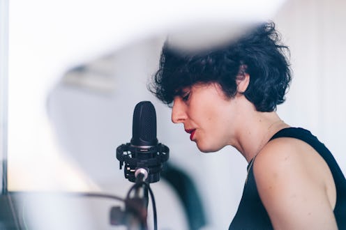 female singing into a microphone