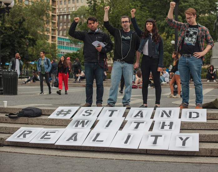 Those involved in The Sparrow Project stand with a small display they set up  in New York, USA, on 9...