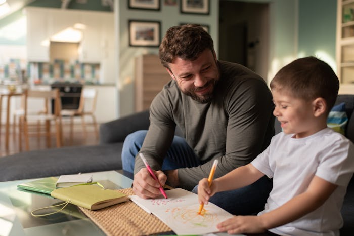 dad and little boy coloring together